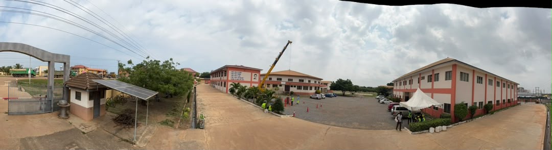 Wide panoramic view of campus grounds, main entrance and workshop facilities